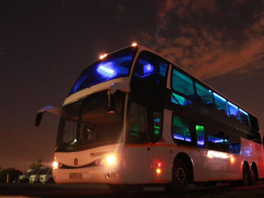 Double decker party bus lit up at night in Gauteng