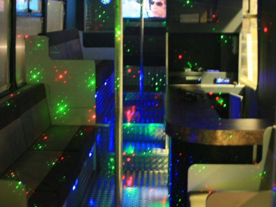 Party bus lounge seating with coloured lighting