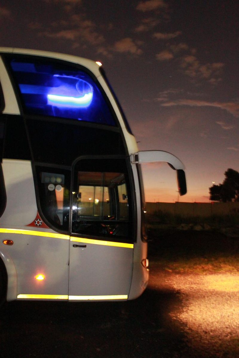 Party coach at dusk with door open ready for boarding