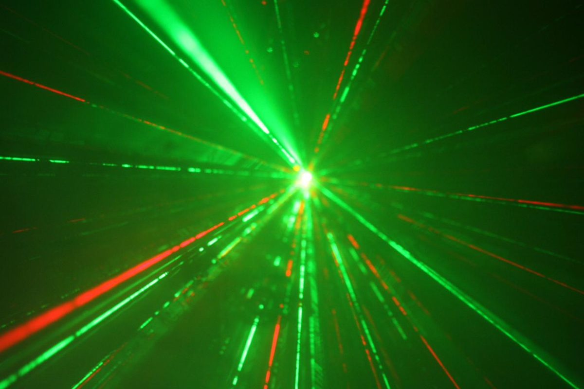 Green and red laser burst inside a party bus