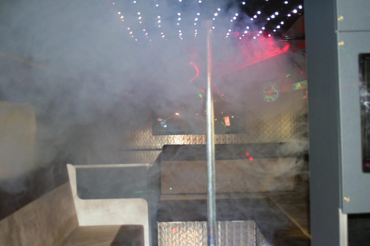 Smoke machine effect filling a party bus aisle