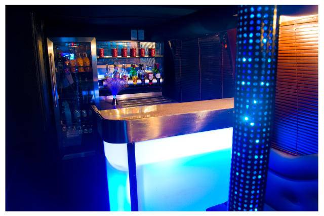 Onboard bar with LED lighting inside a party bus